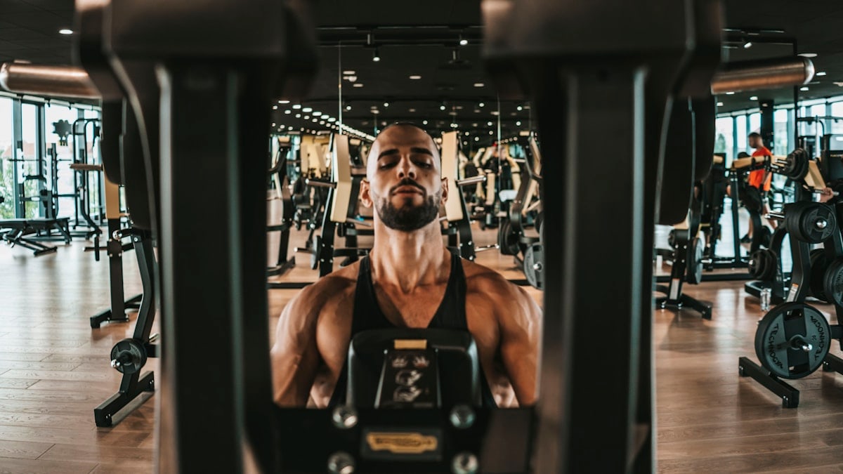a man working out on a machine in a gym